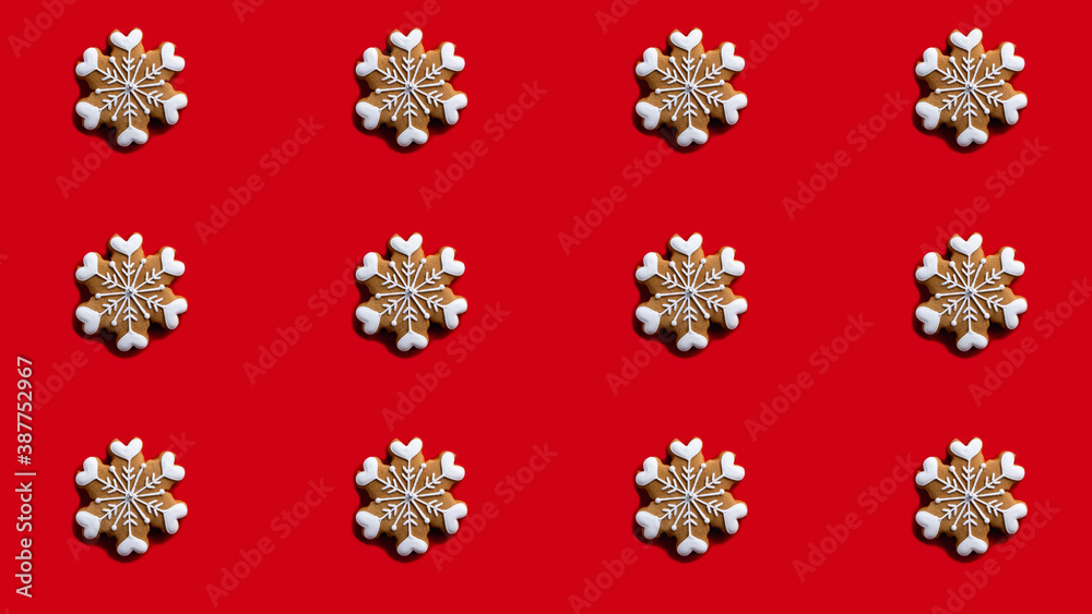 Red Xmas background. Snowflake seamless pattern. New Year party ornament. Brown gingerbread biscuit with white icing minimalist symmetrical composition isolated on bright. Red Xmas background. Snowflake seamless pattern. New Year party ornament. Brown gingerbread biscuit with white icing minimalist symmetrical composition isolated on bright.