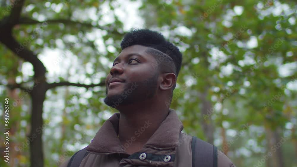 Portrait of positive handsome hipster bearded african american backpacker on adventure trek looking at scenic view of beautiful autumn nature, enjoying active healthy lifestyle during hiking, Portrait of positive handsome hipster bearded african american backpacker on adventure trek looking at scenic view of beautiful autumn nature, enjoying active healthy lifestyle during hiking,