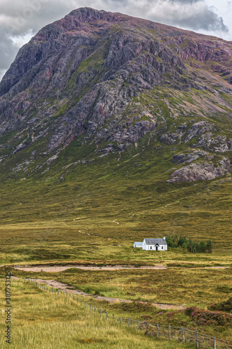 Stob Dearg, Buachaille Etive Mòr at the entrance to Glencoe valley in the Highlands of Scotland where a narrow path across the moors leads to a remote cottage. photo