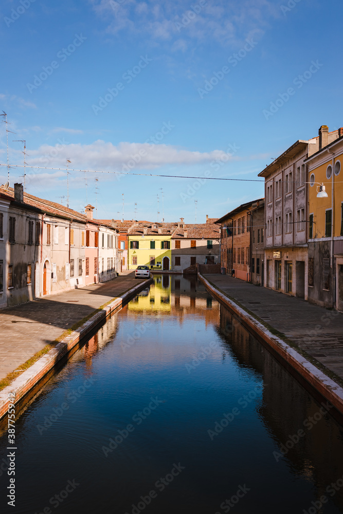 Comacchio, Ferrara / Italy - August 2020: View of the historic center of Comacchio with its main canal, sky with clouds