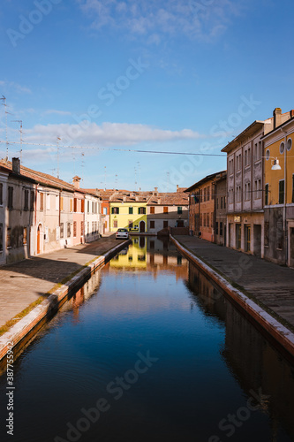 Comacchio, Ferrara / Italy - August 2020: View of the historic center of Comacchio with its main canal, sky with clouds © Jan Cattaneo