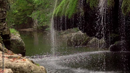 The unique beautiful Bigar waterfall full of green moss, Bozovici, Caras-Severin, Romania. Slow motion photo