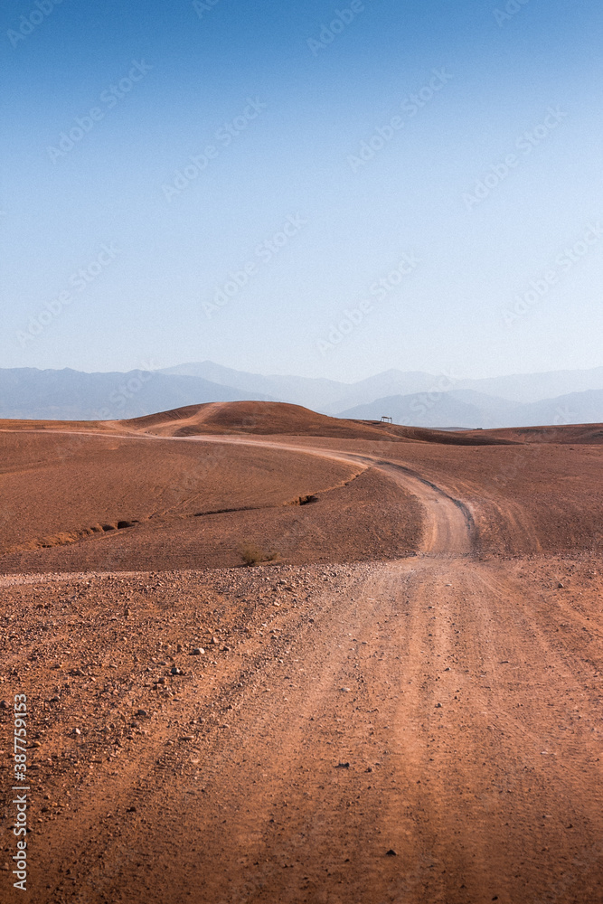 Sand trail in the dunes and mountains in the background Sand trail in the dunes and mountains in the background
