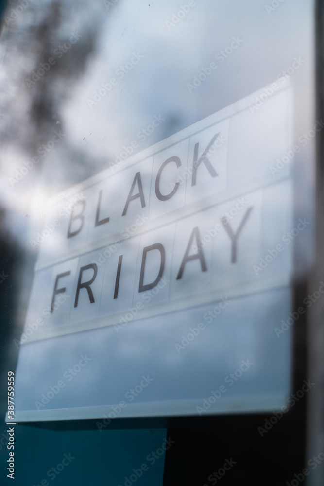 Lightbox Sign Black Friday Sale behind a glass door of the cafe.Concept Black friday , season sales time.