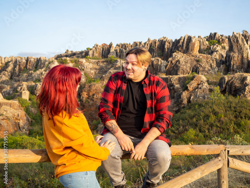 Pareja joven disfrutando del paisaje de el cerro del hierro en sevilla, andalucia, españa photo