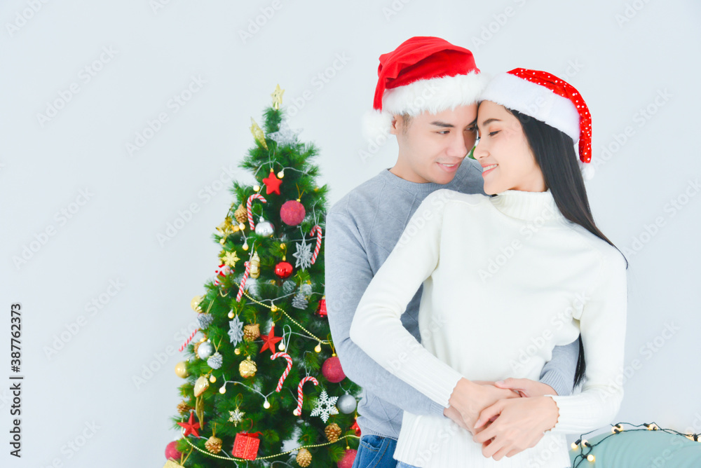 Romantic asian couple in love feeling,spending time on christmas eve together, woman and man enjoying perfect relationships at home.