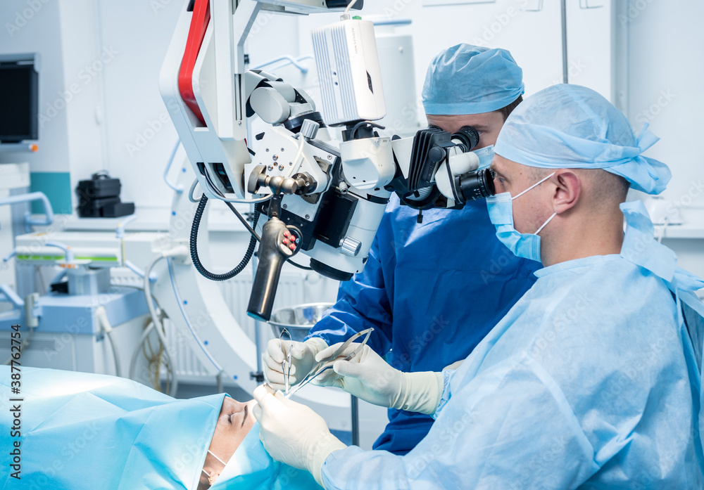 A team of surgeons performing brain surgery to remove a tumor. A team of surgeons performing brain surgery to remove a tumor.