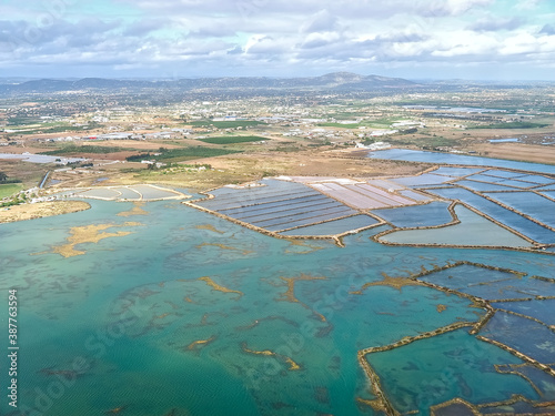 Aerial view of salt pans at the beautiful Algarve coast in Portugal seen on a flight to Faro airport