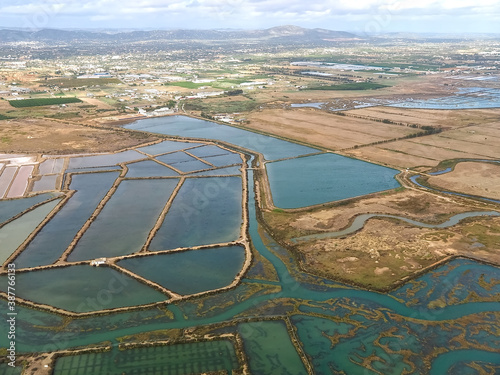 Aerial view of salt pans at the beautiful Algarve coast in Portugal seen on a flight to Faro airport