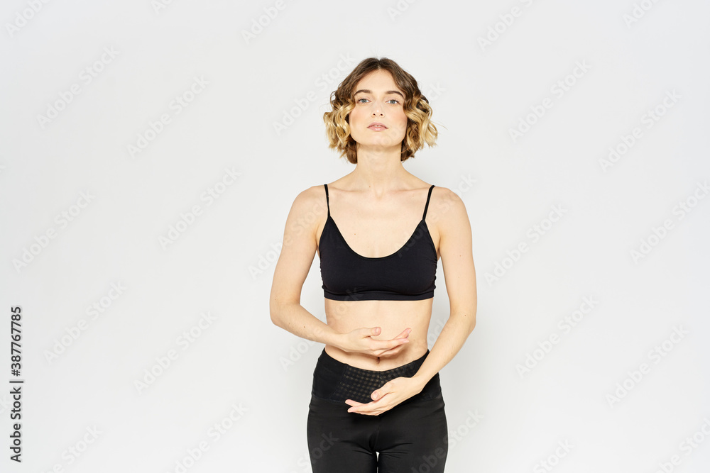 Woman in sportswear on a light background exercise fitness sport balance model Woman in sportswear on a light background exercise fitness sport balance model
