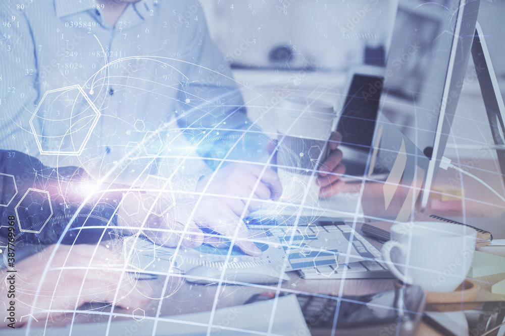 Double exposure of world map hologram with man working on computer on background. Concept of worldwideweb. Double exposure of world map hologram with man working on computer on background. Concept of worldwideweb.