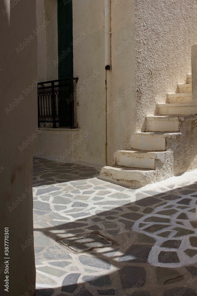 Traditional road in Naxos island, while whitening the cobblestone floor Traditional road in Naxos island, while whitening the cobblestone floor