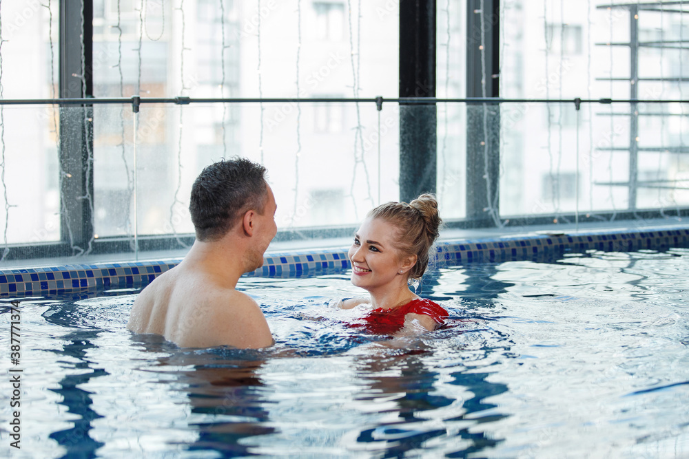 Man and woman leisure in the pool.
