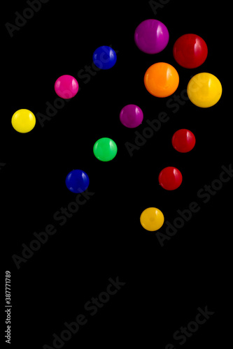 background frame made of colored magnetic paper clips on black background with space for text