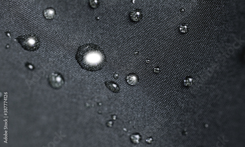 Waterproof fabric, clothing with waterdrops. Rain drops on water resistant textile waterproof coating