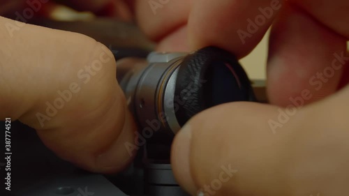 A close-up shot of a hand holding an nd or pl neutral density filter for unmanned cameras, drones, or copters. photo