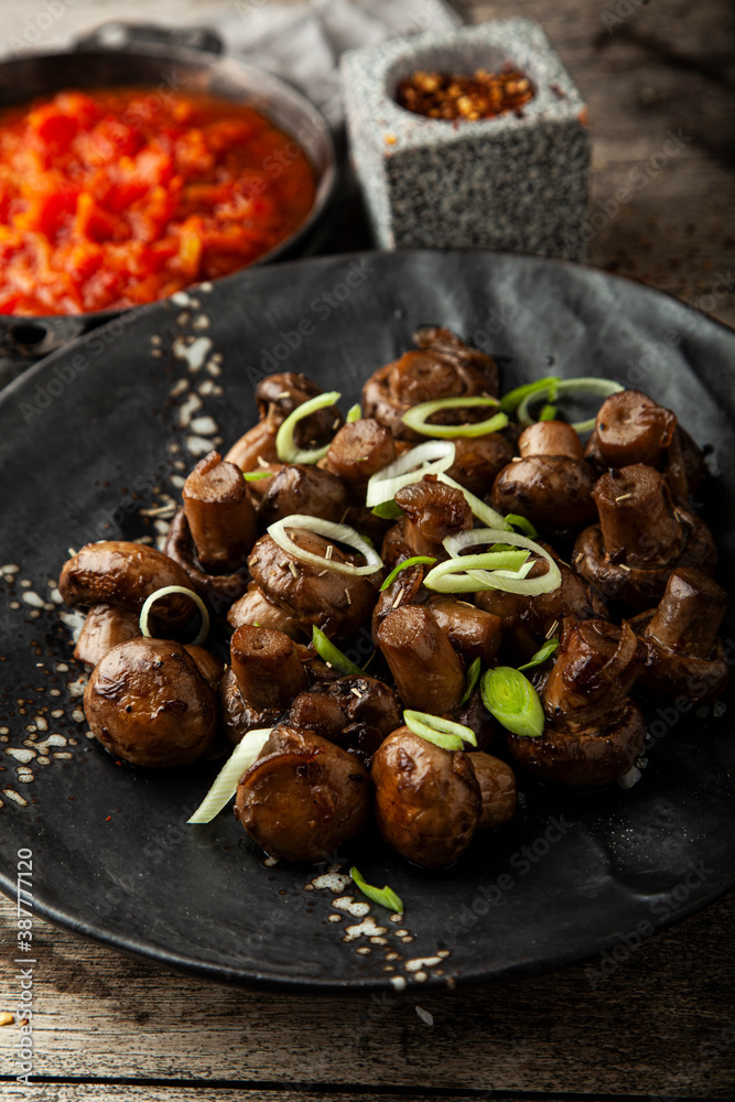 Fried marinated mushrooms with onions and garlic on a plate Fried marinated mushrooms with onions and garlic on a plate