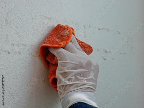 Canvas Print A piece of cloth, soaked with thinner, in a hand of a painter being used to remo