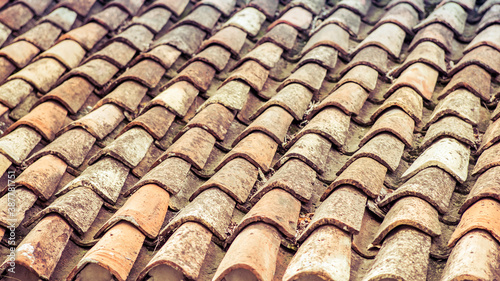 Old tiled roof, brown and gray tiles. Background.