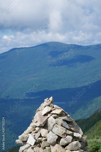 Landscape of mountains with a cairn in the foreground