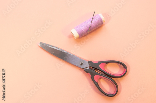 scissors and thread for cutting and sewing photo