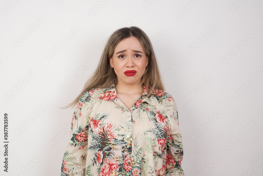 Beautiful face of sad woman crying desperate and depressed with tears on her eyes suffering pain and depression isolated on grey background in sadness facial expression and emotion concept. Beautiful face of sad woman crying desperate and depressed with tears on her eyes suffering pain and depression isolated on grey background in sadness facial expression and emotion concept.