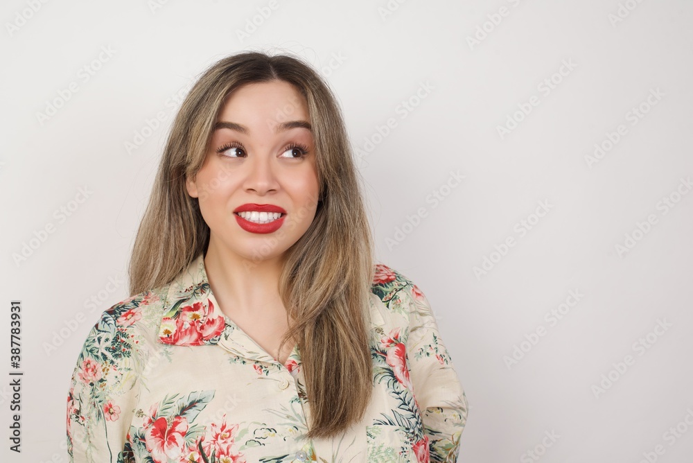 Oops! Portrait of female with specific appearance clenches teeth and looks confusedly aside, realises her bad mistake, poses against copy area for your advertising or promotional background. Oops! Portrait of female with specific appearance clenches teeth and looks confusedly aside, realises her bad mistake, poses against copy area for your advertising or promotional background.