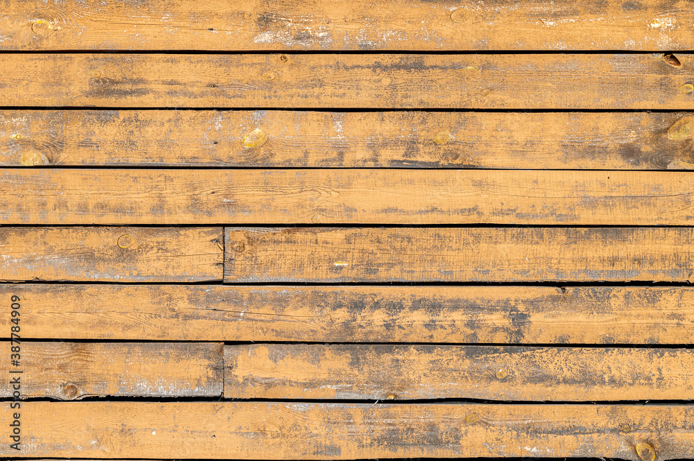 Obraz premium close-up of a wall made of wooden planks with remnants of old paint and nails. Natural background.