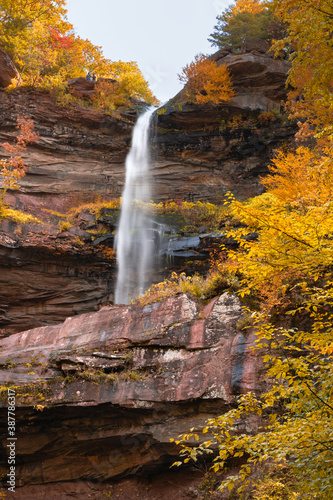 Large waterfall surrounded by vibrant fall foliage color. Kaaterskill Falls, Woodstock New York photo