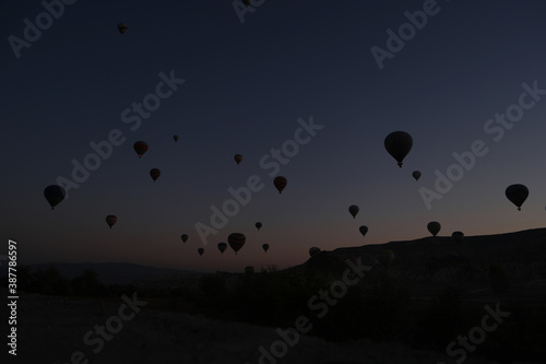 Silhouettes of hot air balloons at sunset sky. Goreme National Park. Cappadokia, Turkey.