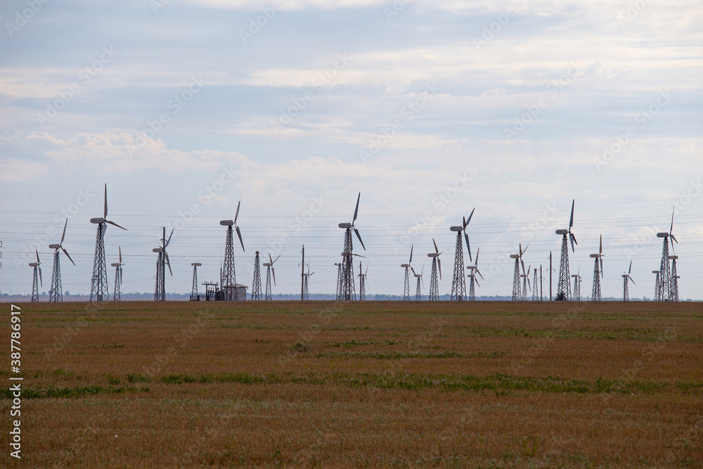 A wind farm with many wind turbines on the field
A wind farm with many wind turbines on the field
