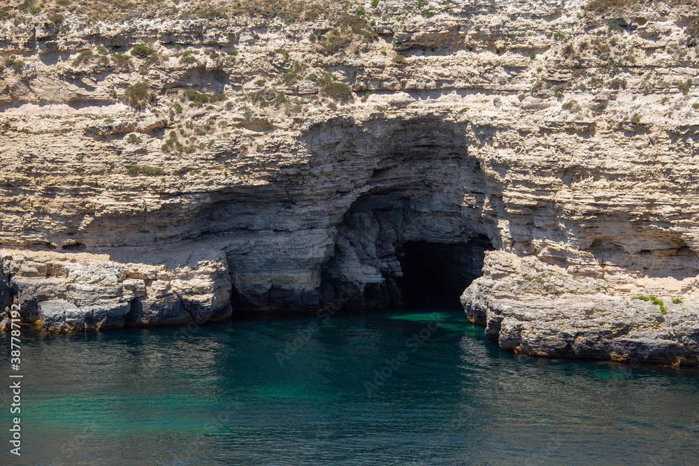 Caves along the sea. Beautiful seascape in summer.