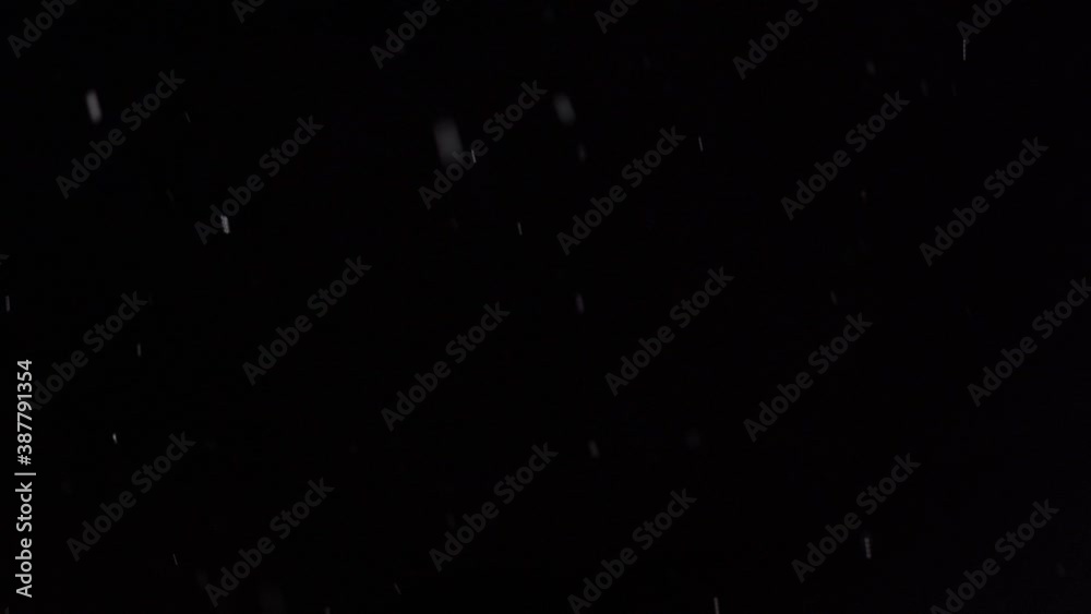 Snow falling in winter isolated on black background Snow falling in winter isolated on black background