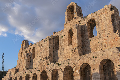 Picturesque view of Greek ruins of Odeon of Herodes Atticus (161AD) - stone Roman theater at the Acropolis hill on sunset. Athens, Greece. © dbrnjhrj