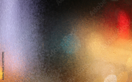Blur Water drops on wet window glass with city lights.