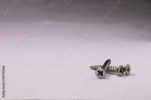 Metal self-tapping screws on a white background.