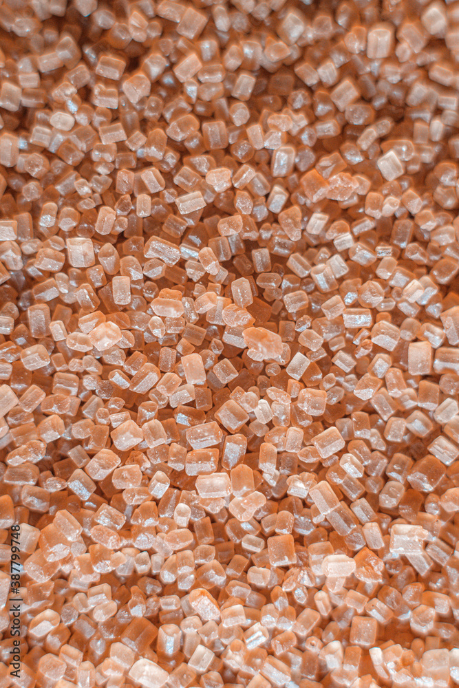 Image of cane sugar. The sugar is in a scattered state. Granules are