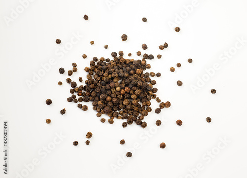 Fototapeta Naklejka Na Ścianę i Meble -  Black peppercorns top down view. Isolated on white background