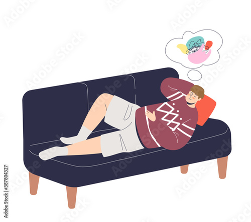 Man lying on couch and daydreaming relaxing and using imagination while having rest