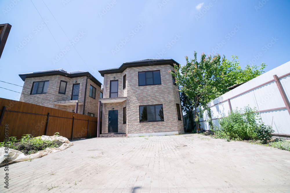Exterior of a large two story brick residential home containing plenty of copy space,