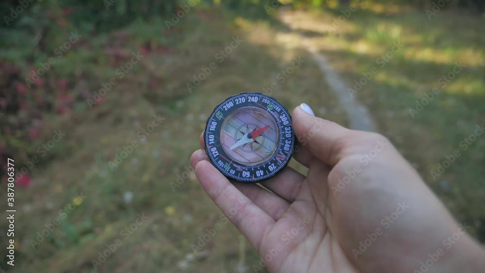 close up a male tourist holds glass compass in his hands while in the forest. Slow motion 4k close up a male tourist holds glass compass in his hands while in the forest. Slow motion 4k