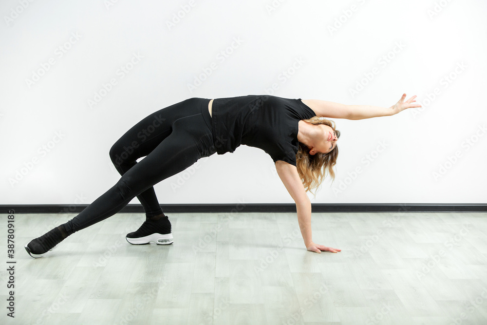 Beautiful girl hair engaged in yoga stretching fitness white background