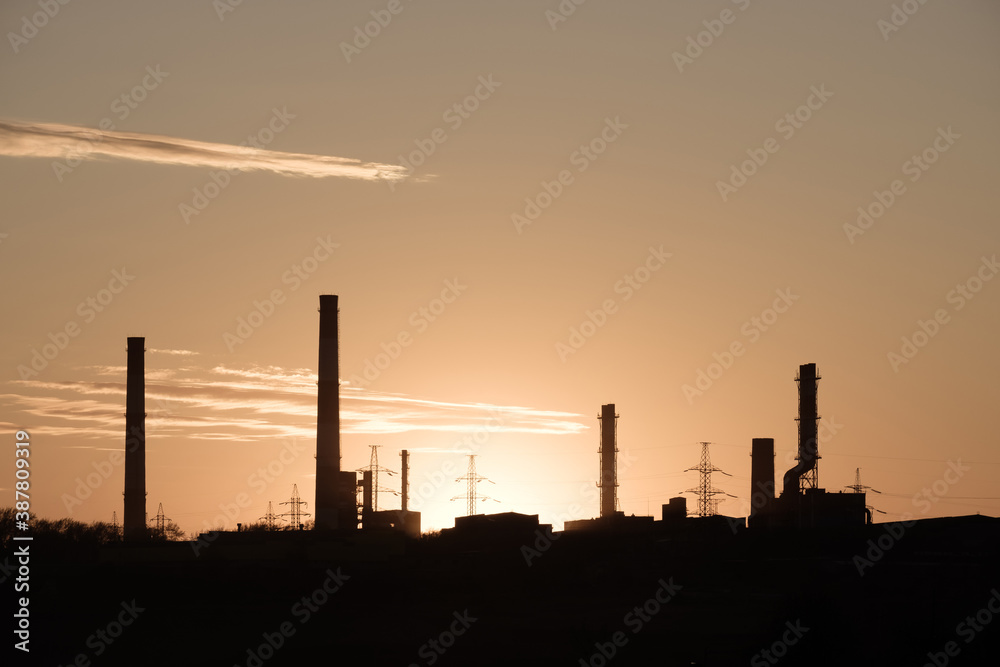 silhouettes of factory chimneys without smoke, idle enterprise