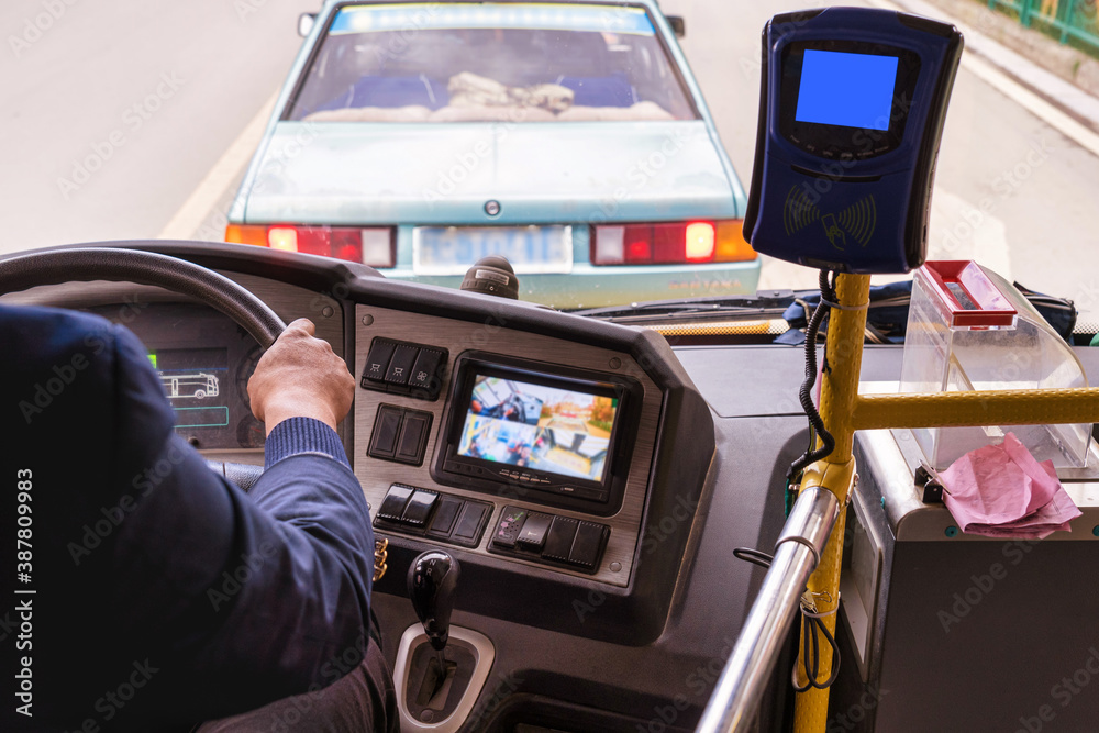 Closeup Chinese Driver hand driving the electric bus or EV around Dukezong ancient Old Town, Lijiang City, in Yunnan, China. Economic Technology and transportation concept,