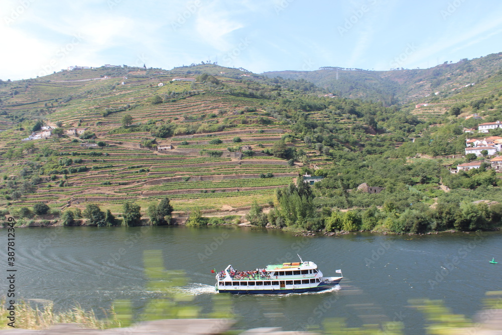 View of the Douro mountains and river with a tourism boat