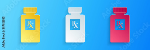Paper cut Pill bottle with Rx sign and pills icon isolated on blue background. Pharmacy design. Rx as a prescription symbol on drug medicine bottle. Paper art style. Vector.