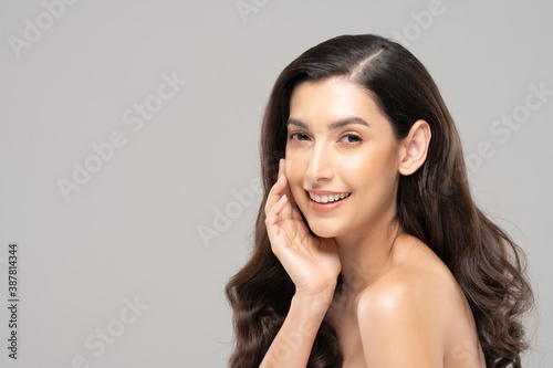 Beautiful Glamour indian woman touch cheek smile with clean and fresh skin Happiness and cheerful with positive emotional,isolate on grey background,Beauty Cosmetics and spa Facial treatment Concept