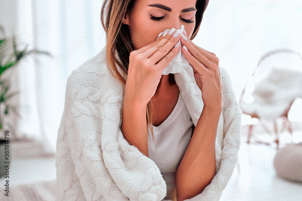 Sick woman sneezing into tissue. Allergy reaction. Flu. Woman caught cold. Sick woman sneezing into tissue. Allergy reaction. Flu. Woman caught cold.
