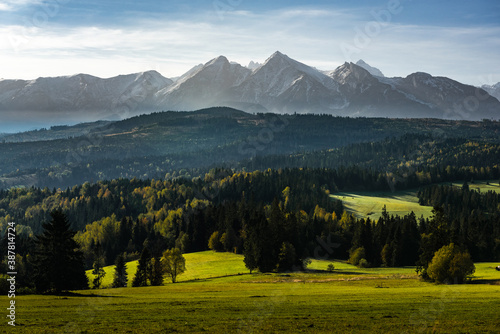 Scenic View at Snow Covered Mountains Peaks and Colorful Foliage in Tatra Mountains.