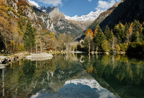 panorama view of small lake with reflections and multicolor woods  in autumn season lake in Val di Mello  Val Masino   Italy - lombardy.